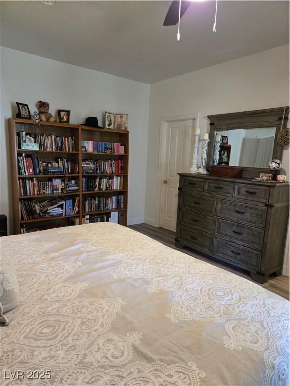 bedroom with baseboards, ceiling fan, and wood finished floors