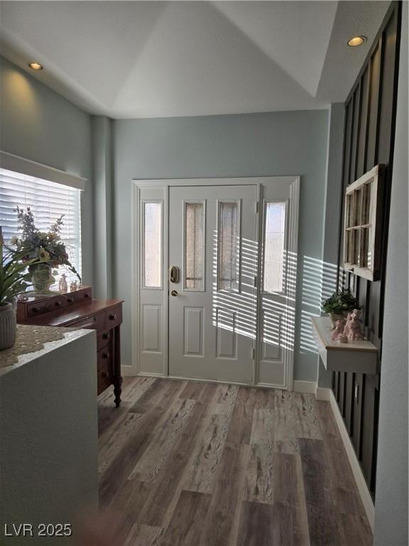 foyer featuring wood finished floors, baseboards, and recessed lighting