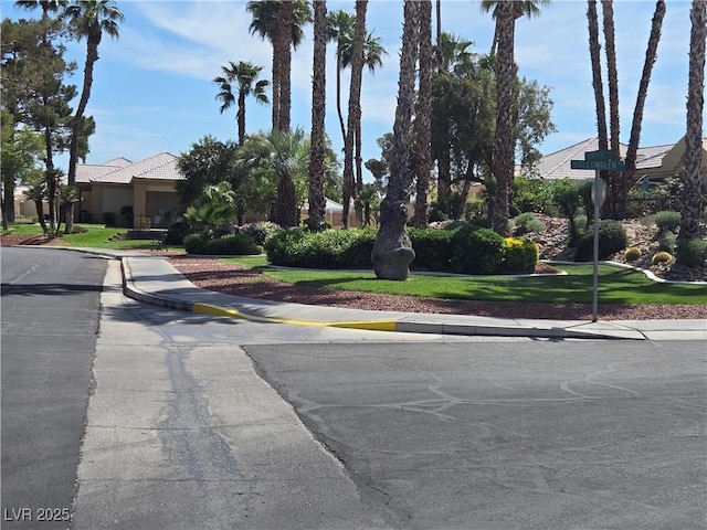 view of road with sidewalks, curbs, and traffic signs