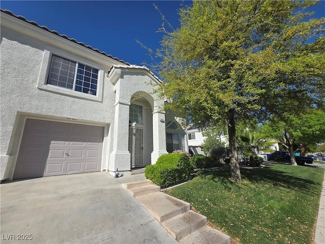 traditional home with a tiled roof, stucco siding, a front lawn, a garage, and driveway
