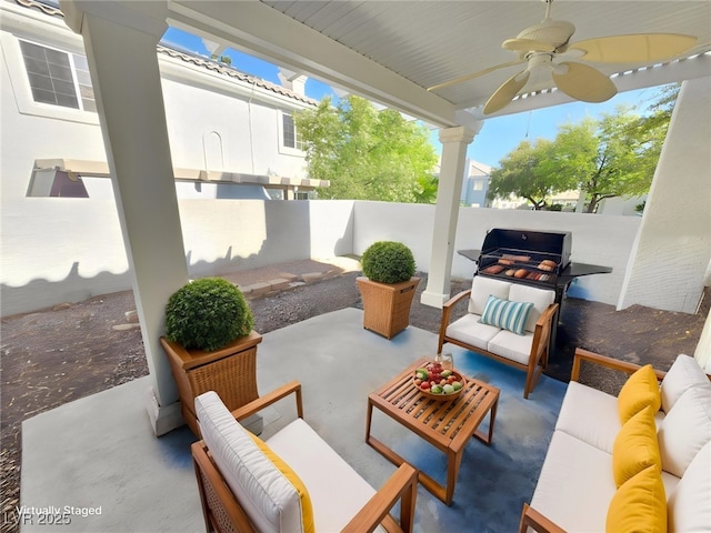 view of patio / terrace with an outdoor living space, a fenced backyard, and a ceiling fan