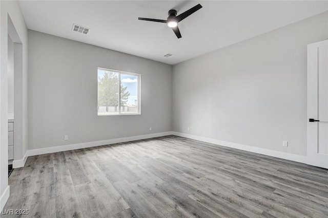 2110 S Manzanita Dr, Pahrump, NV 89048 - spare room with wood finished floors, ceiling fan, baseboards, and visible vents