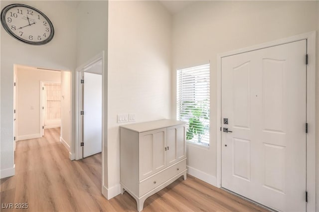 8513 Glenmount Dr, Las Vegas, NV 89134 - entryway with a towering ceiling, light wood-style flooring, and baseboards