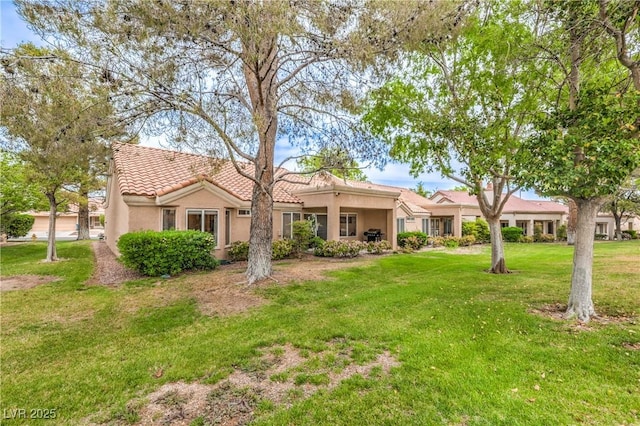 8513 Glenmount Dr, Las Vegas, NV 89134 - mediterranean / spanish house with a tile roof, stucco siding, and a front lawn