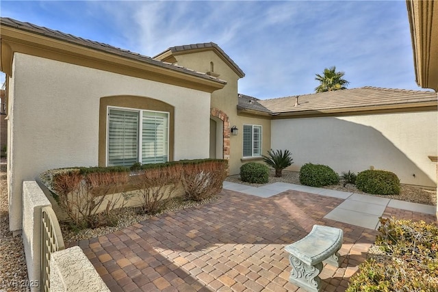 2229 Suffron Hills Ct, Henderson, NV 89044 - property entrance featuring a patio area, stucco siding, and a tiled roof