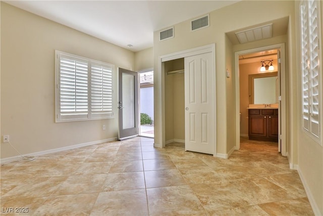 2229 Suffron Hills Ct, Henderson, NV 89044 - unfurnished bedroom with baseboards, a closet, a sink, and visible vents