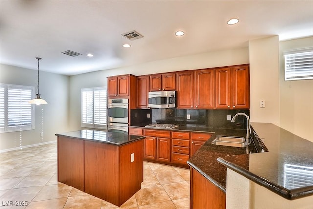 2229 Suffron Hills Ct, Henderson, NV 89044 - kitchen featuring a sink, visible vents, a peninsula, and stainless steel appliances