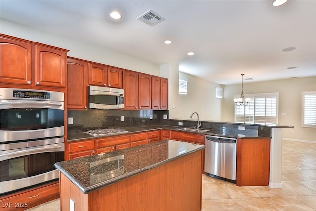 2229 Suffron Hills Ct, Henderson, NV 89044 - kitchen featuring visible vents, decorative light fixtures, a sink, a peninsula, and stainless steel appliances