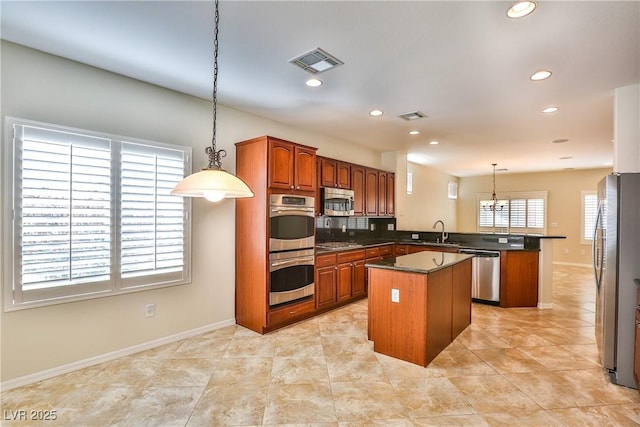 2229 Suffron Hills Ct, Henderson, NV 89044 - kitchen featuring a peninsula, visible vents, a center island, and appliances with stainless steel finishes