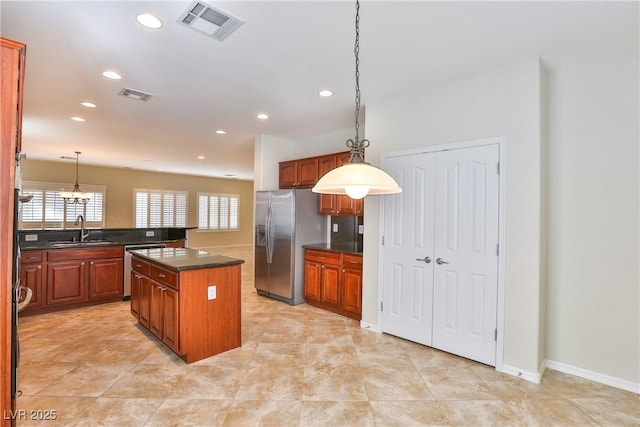 2229 Suffron Hills Ct, Henderson, NV 89044 - kitchen featuring visible vents, stainless steel fridge, a sink, dark countertops, and recessed lighting