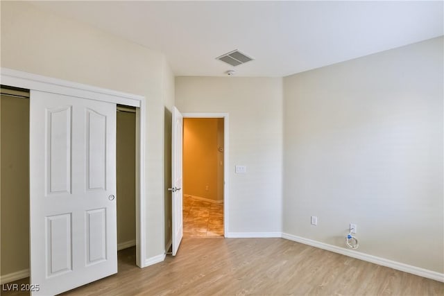 2229 Suffron Hills Ct, Henderson, NV 89044 - unfurnished bedroom featuring a closet, light wood finished floors, baseboards, and visible vents