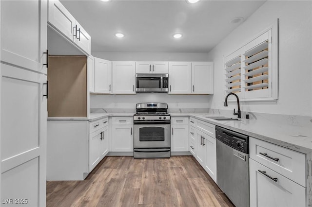 2851 S Valley View Blvd Unit 1098, Las Vegas, NV 89102 - kitchen with appliances with stainless steel finishes, a sink, white cabinets, light stone counters, and recessed lighting