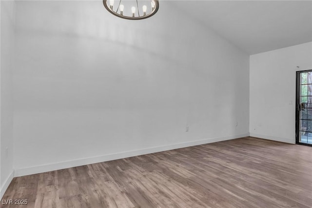 2851 S Valley View Blvd Unit 1098, Las Vegas, NV 89102 - unfurnished room featuring a chandelier, wood finished floors, baseboards, and vaulted ceiling