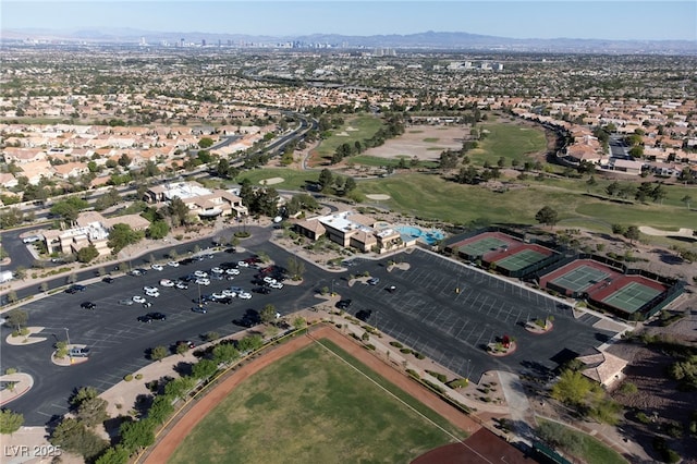 drone / aerial view featuring a residential view, a mountain view, and golf course view