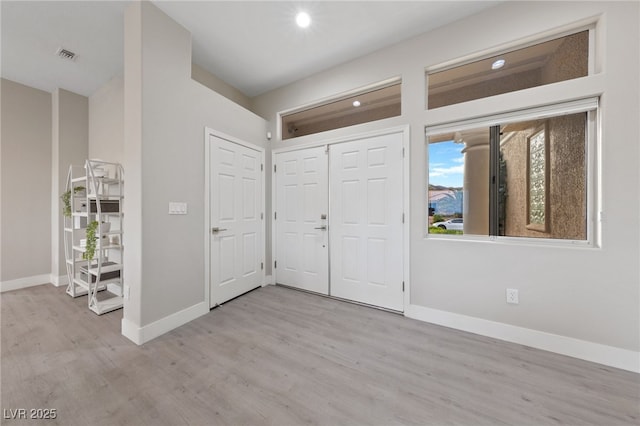 foyer entrance featuring recessed lighting, baseboards, visible vents, and light wood-style floors