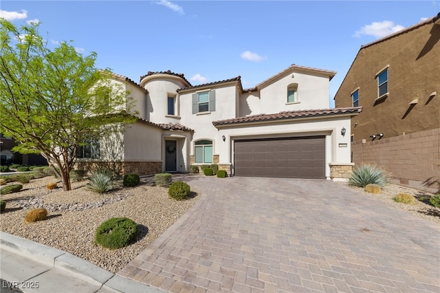 12665 Cooks Bay Ct, Las Vegas, NV 89141 - mediterranean / spanish house with a tiled roof, stone siding, a garage, and decorative driveway