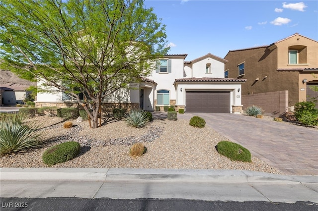 12665 Cooks Bay Ct, Las Vegas, NV 89141 - mediterranean / spanish-style home with stucco siding, driveway, stone siding, an attached garage, and a tile roof