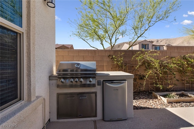 12665 Cooks Bay Ct, Las Vegas, NV 89141 - view of patio / terrace with a garden, fence, area for grilling, and an outdoor kitchen
