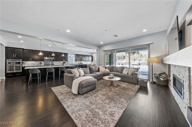 12665 Cooks Bay Ct, Las Vegas, NV 89141 - living room with dark wood finished floors, visible vents, and recessed lighting