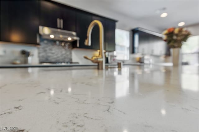 12665 Cooks Bay Ct, Las Vegas, NV 89141 - details featuring stone countertops, backsplash, and dark cabinets