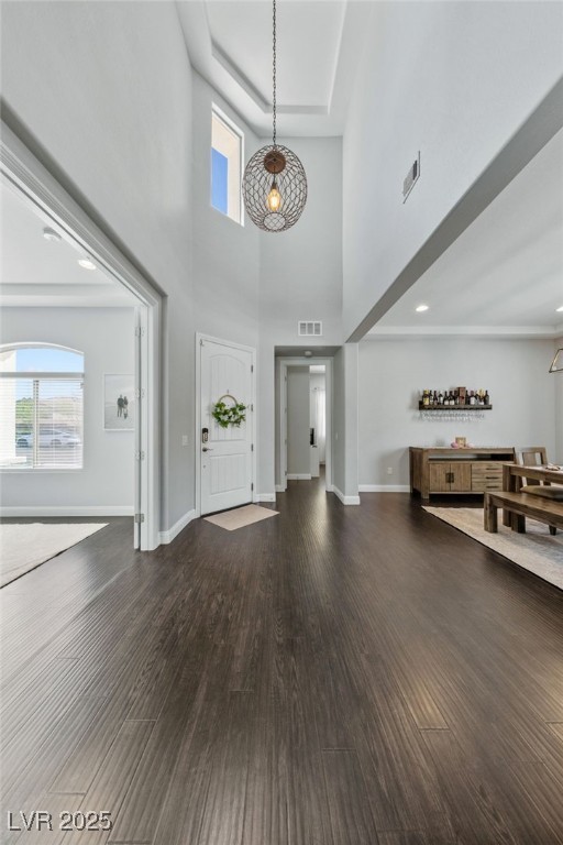 12665 Cooks Bay Ct, Las Vegas, NV 89141 - foyer entrance featuring visible vents, baseboards, wood finished floors, and a towering ceiling