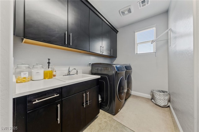 12665 Cooks Bay Ct, Las Vegas, NV 89141 - laundry area with visible vents, baseboards, separate washer and dryer, a sink, and cabinet space