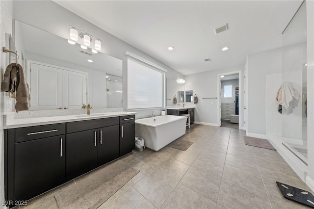 12665 Cooks Bay Ct, Las Vegas, NV 89141 - full bathroom featuring a shower stall, two vanities, visible vents, and a sink