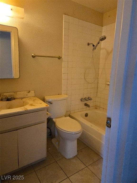 bathroom with toilet, tile patterned floors, vanity, and  shower combination