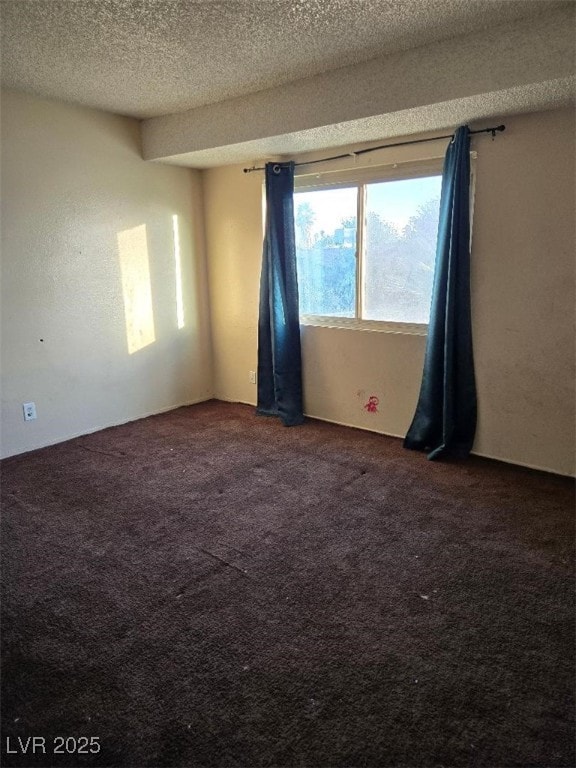 carpeted spare room with a textured ceiling