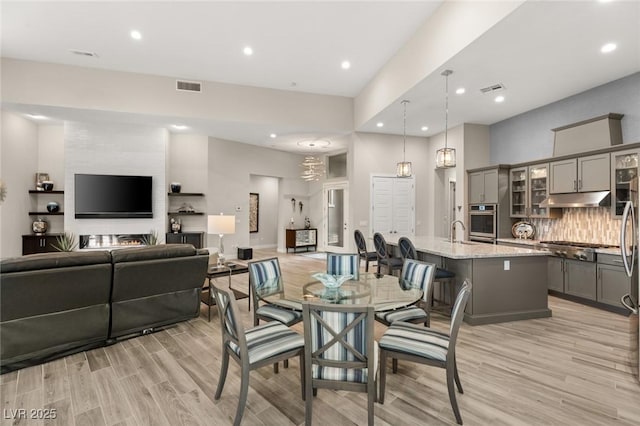 dining area featuring recessed lighting, light wood-style flooring, and visible vents