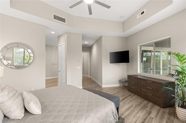 bedroom with light wood finished floors, baseboards, and visible vents