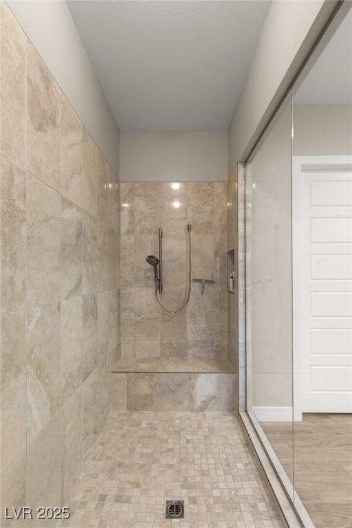 bathroom with a tile shower