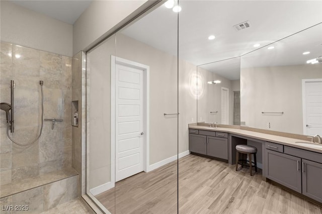 bathroom with double vanity, visible vents, and walk in shower