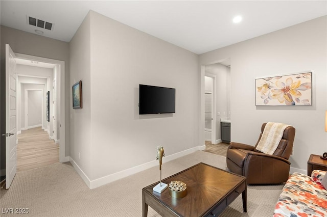 living room featuring light colored carpet, baseboards, visible vents, and recessed lighting
