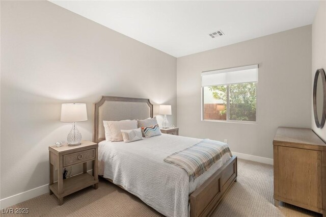 bedroom featuring visible vents, baseboards, and light colored carpet