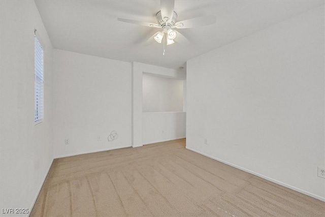 empty room with ceiling fan, carpet floors, and baseboards