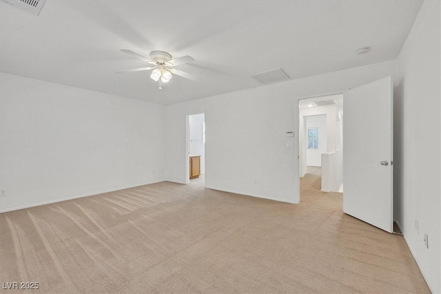 unfurnished room with a ceiling fan, light carpet, a smoke detector, and baseboards