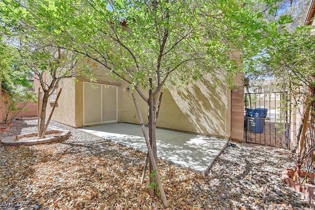 view of yard with fence, a patio, and a gate