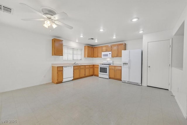 kitchen featuring white appliances, a sink, light countertops, a ceiling fan, and recessed lighting