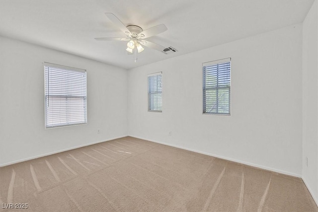 spare room featuring carpet flooring, ceiling fan, and baseboards