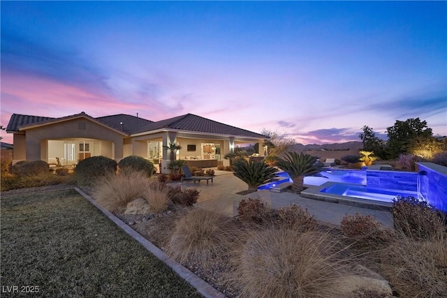 421 Foxhall Rd, Henderson, NV 89002 - back of house featuring an outdoor pool, a tiled roof, a patio, an in ground hot tub, and stucco siding