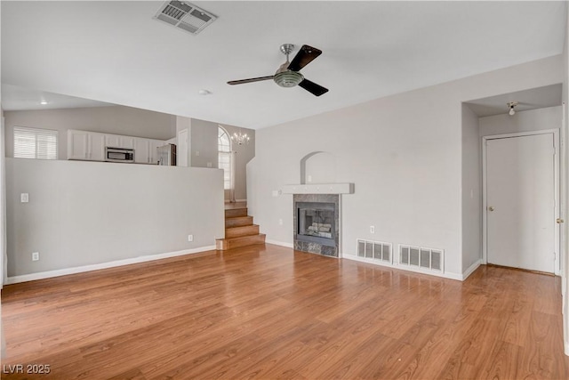 unfurnished living room featuring visible vents, light wood-style floors, and ceiling fan