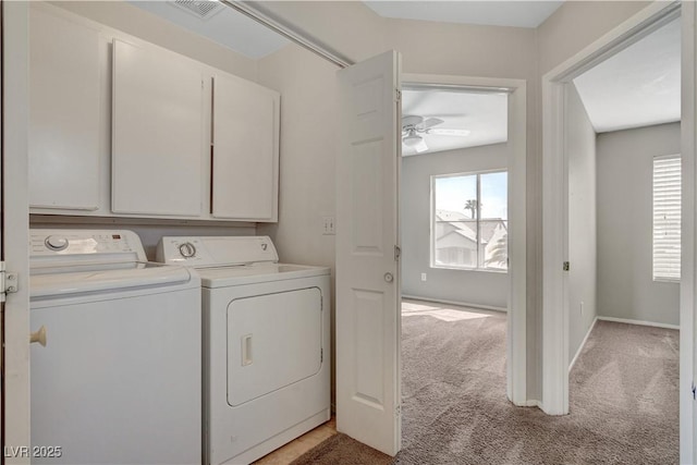 washroom with washing machine and dryer, light carpet, cabinet space, and a wealth of natural light