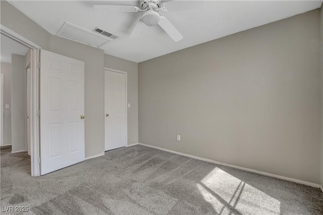 unfurnished bedroom featuring visible vents, carpet flooring, baseboards, and ceiling fan