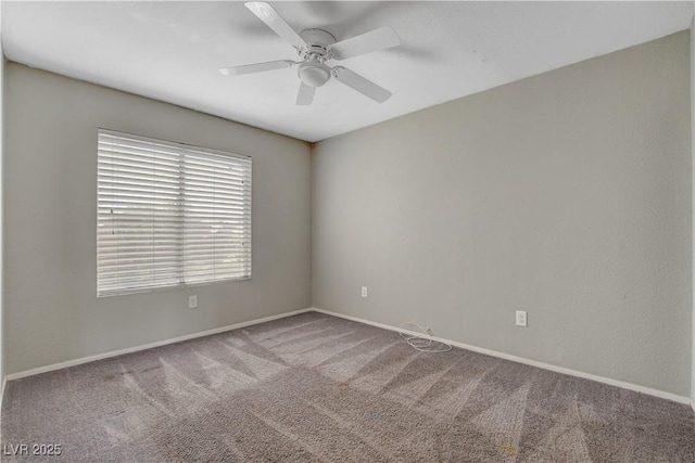 spare room featuring baseboards, carpet flooring, and ceiling fan