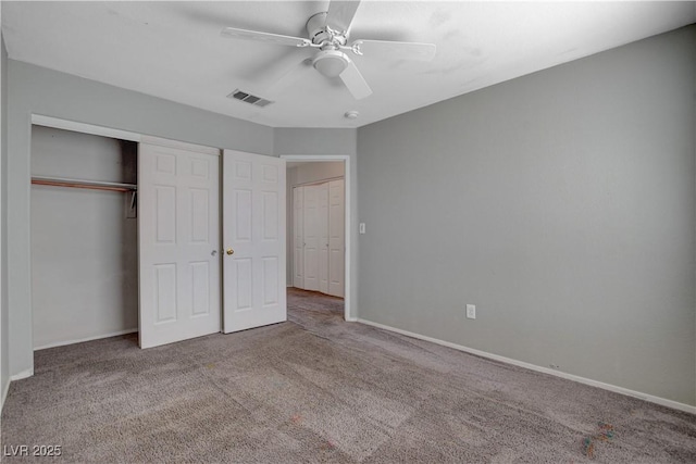 unfurnished bedroom with carpet floors, visible vents, and baseboards