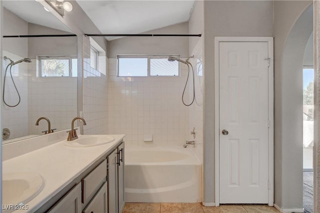 full bath featuring shower / washtub combination, double vanity, a sink, and a wealth of natural light
