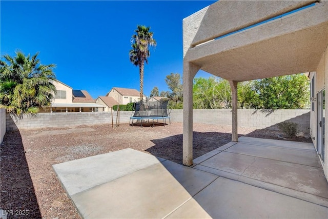 view of patio / terrace with a fenced backyard and a trampoline