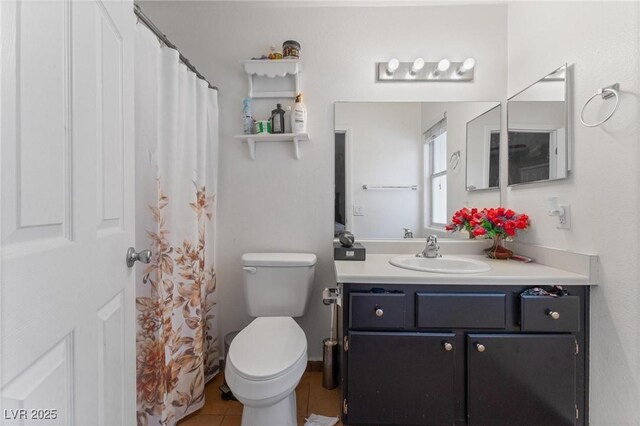 full bathroom featuring tile patterned flooring, vanity, and toilet
