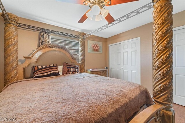 bedroom with a closet, wood finished floors, and ceiling fan